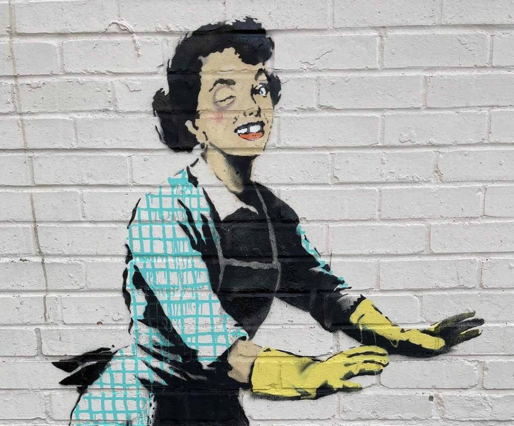 La imagen de alto impacto de Banksy de la mujer con el ojo morado, sin un diente, y con guantes de limpieza. 