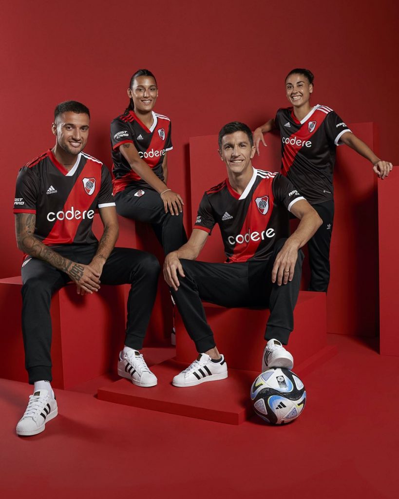 Es la tercera camiseta del Millonario 2023, con base negra y la tradicional banda roja.